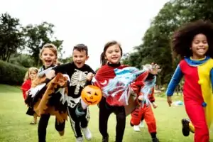 Diverse group of children wearing Halloween costumes.