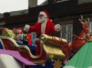 Santa Claus standing in a sleigh during a Santa Claus Parade Quiet Zone