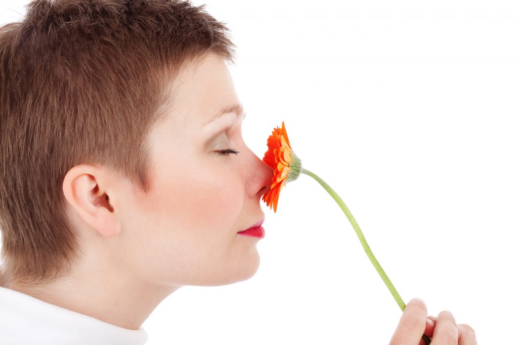 Person smelling flower.