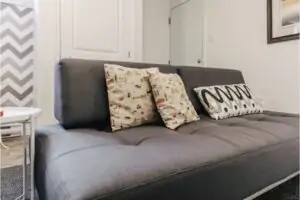 Grey couch with pillows.