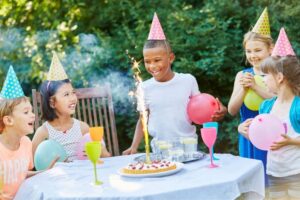 Children smiling at sensory friendly birthday party.