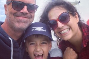 Mother, father and son smiling.