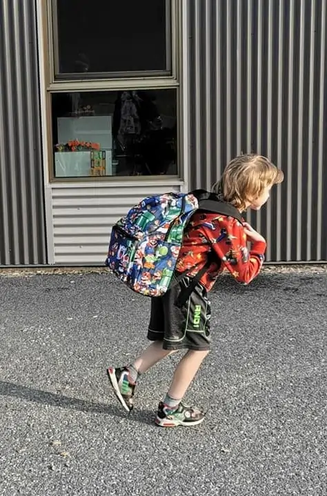 Young boy with backpack going to school
