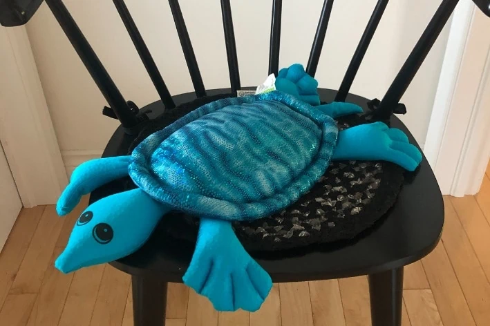 Turtle shaped weighted lap pad.