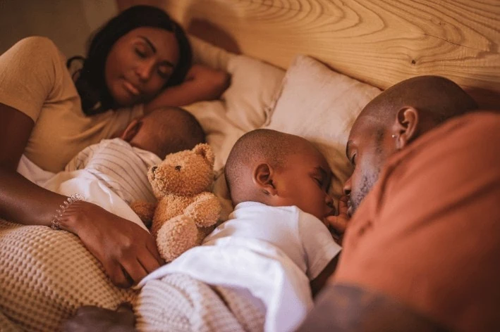 Family of four members sleeping together