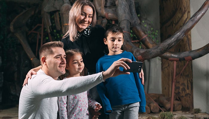 Family of four taking aselfie at a museum