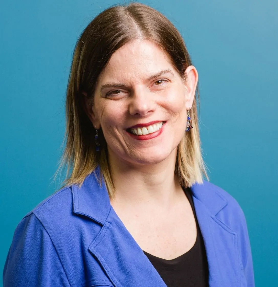 Photo of Christel Seeberger smiling.