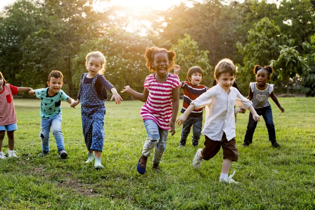 Group of diverse kids playing at the field together