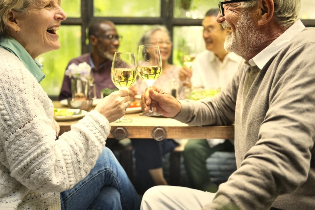 Senior friends having fun at a dinner.