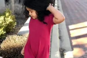 Young girl posing wearing sensory-friendly jumper from Chantilly Comfort Wear..