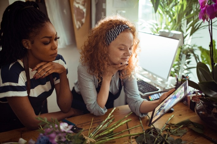 Two young business people running their sensory-friendly business.