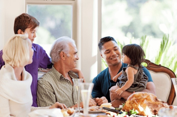Family gathered at dinner table during sensory-friendly Thanksgiving.