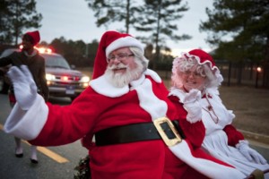 Santa Clause waving at a sensory-friendly parade.
