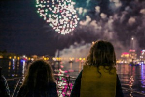 Two young siblings watching sensory-friendly show from boat.