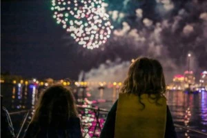 Two young siblings watching sensory-friendly show from boat.