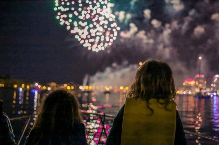 Two young siblings watching sensory-friendly show from boat.
