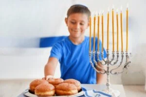 A jewish child excited to grab a donut at a sensory friendly synagogue.