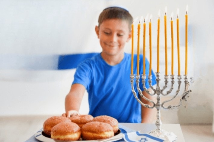 A jewish boy excited to grab a donut at a sensory friendly synagogue.