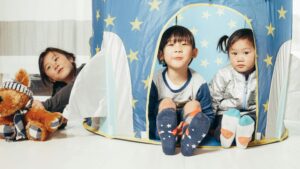 Pre-school children in a tent in a classroom sensory area